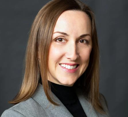 Svitlana Krasynska headshot with a dark grey background